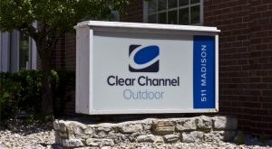 Clear Channel Outdoor (CCO) sign in blue and white outside of building