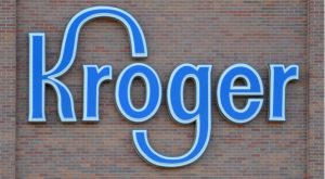 A photo of a Kroger Co (KR) sign on a brick wall.