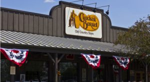 The logo for Cracker Barrel Old Country Store Inc (CBRL) is displayed on a restaurant store front.