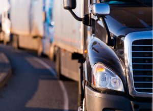 A close up of a tractor trailer truck. Uber layoffs, Uber freight