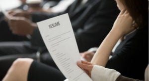 a picture of someone holding a resume in their hand