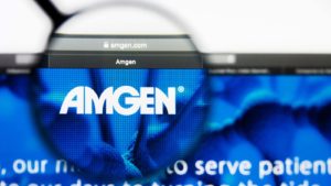 A magnifying glass zooms in on the website for Amgen Inc (AMGN).