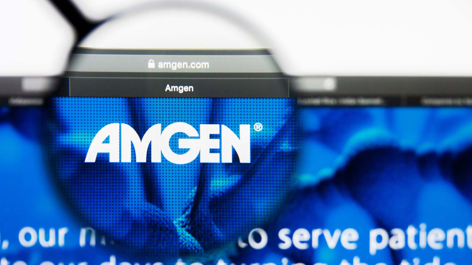 The Amgen (AMGN Stock) logo under a magnifying glass representing a deal for CCXI stock.