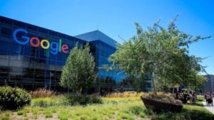 The Alphabet (GOOG GOOGL) logo on the side of a building.