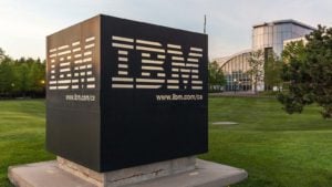 Sign of IBM with Canada Head Office Building in background in Markham, Ontario, Canada. IBM is an American multinational technology company.