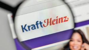 A magnifying glass zooms in on the Kraft Heinz (KHC) website.