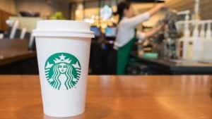 starbucks (SBUX) coffee cup on a counter (Best dividend-paying stocks)