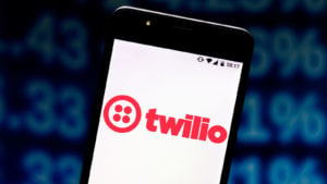 The Twilio (TWLO) logo is displayed over a white background on a smartphone screen.