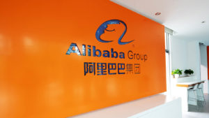 Alibaba sign on orange background in office space. BABA stock