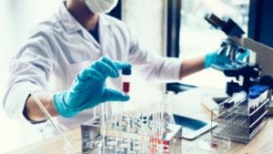 A scientist holding a test tube in a stock image