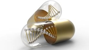 a gold and clear pill capsule contains a representation of a DNA molecule to represent biotech stocks