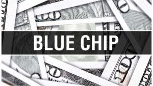 the words "blue chip" in bold font overtop of a pile of cash. Blue-chip stocks