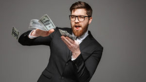 A young man throwing dollar bills.