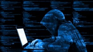 Digital illustration of a hacker wearing a blue sweatshirt.Cybersecurity stocks to sell