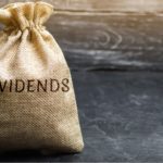 a bag on a table with the word "dividends" on it. represent dividend stocks of all time.