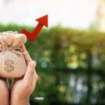 image of hands holding small money bag symbolizing dividend stocks. Stocks That Could Turn $100 into $1,000