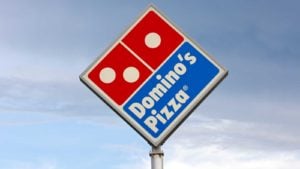 A tall Domino's Pizza (DPZ) sign stands in Eau Claire, Wisconsin. safe stocks to buy