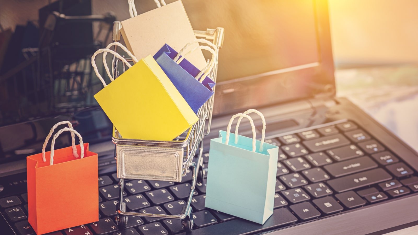 Image of small shopping bags sitting in a shopping cart on a computer, ATER