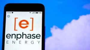 mobile phone screen with enphase energy (ENPH) logo on it to represent renewable energy stocks