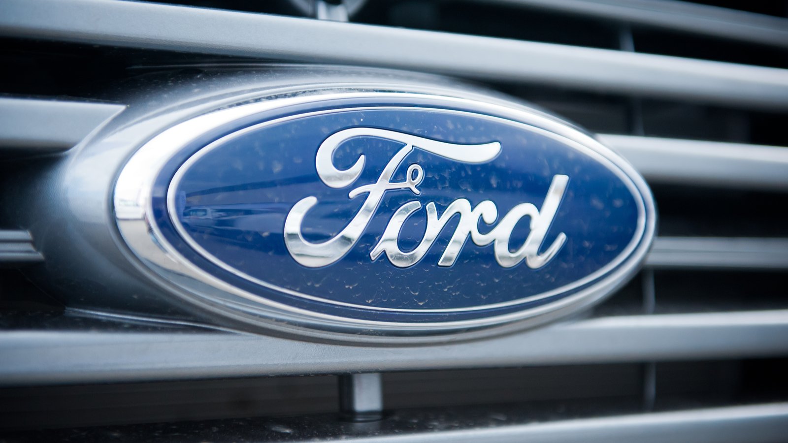 Ford (F) logo badge on grill of car