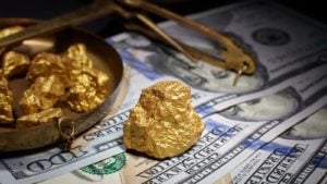 Gold nuggets on top of American paper money.