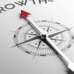 compass with an arrow pointing toward growth to represent growth stocks