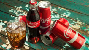 coca-cola bottles and cans. coke is a blue-chip stocks