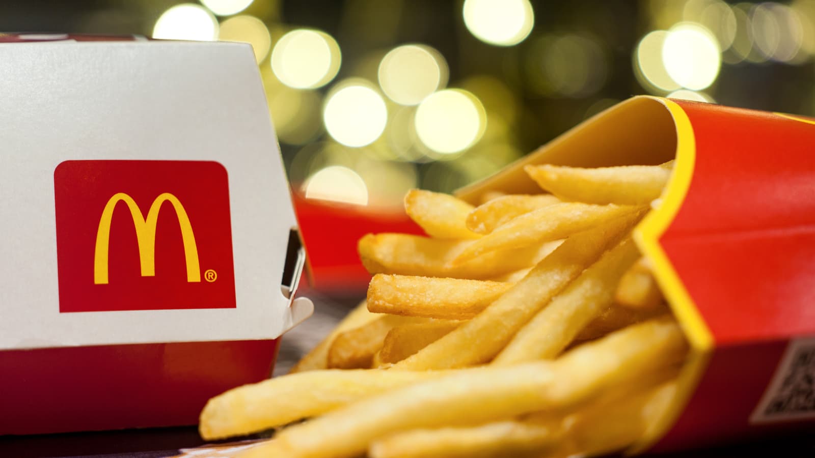 A McDonald's (MCD stock) burger box and fries rest on a flat surface.