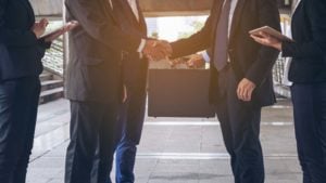 Image of two business people shaking hands representing SREV stock.