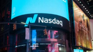 Nasdaq 100 stocks: the Nasdaq building lit up at night