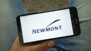 Newmont (NEM) logo on a mobile phone screen precious metals stocks