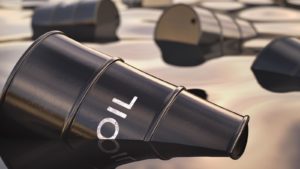 Black oil barrel that reads "oil" on the side in a pool of oil with other barrels representing Is Oil Entering a Bear Market.