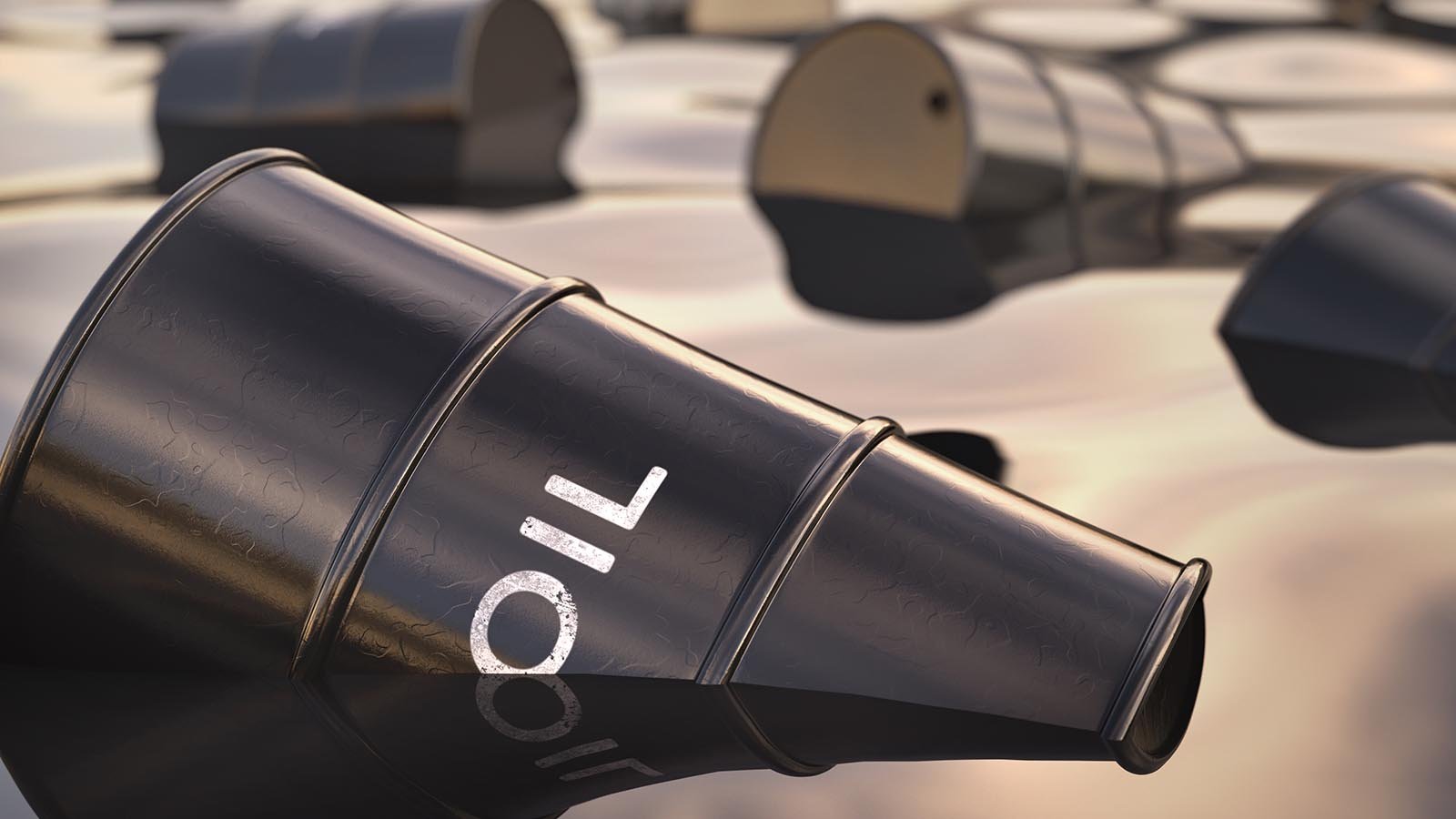 Black oil barrel that reads "oil" on the side in a pool of oil with other barrels
