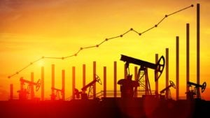 Illustration of oil pump jacks on sunset sky background