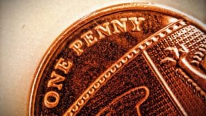 A close up photo of a penny representing top penny stocks today.