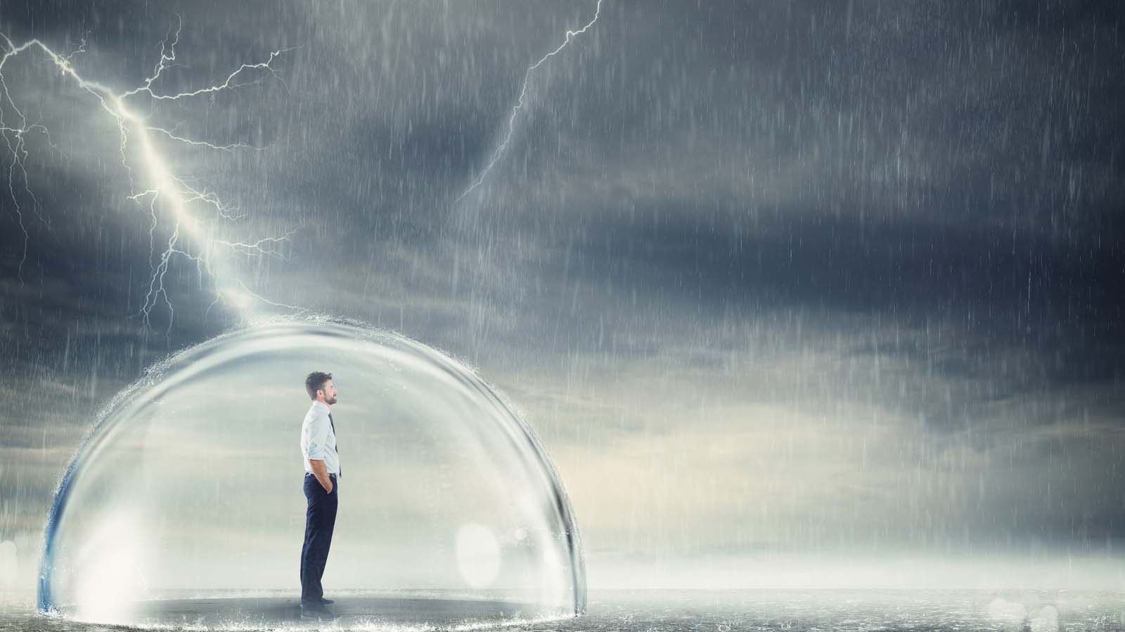 man in bubble outdoors protected from a dark storm, rain and lightning