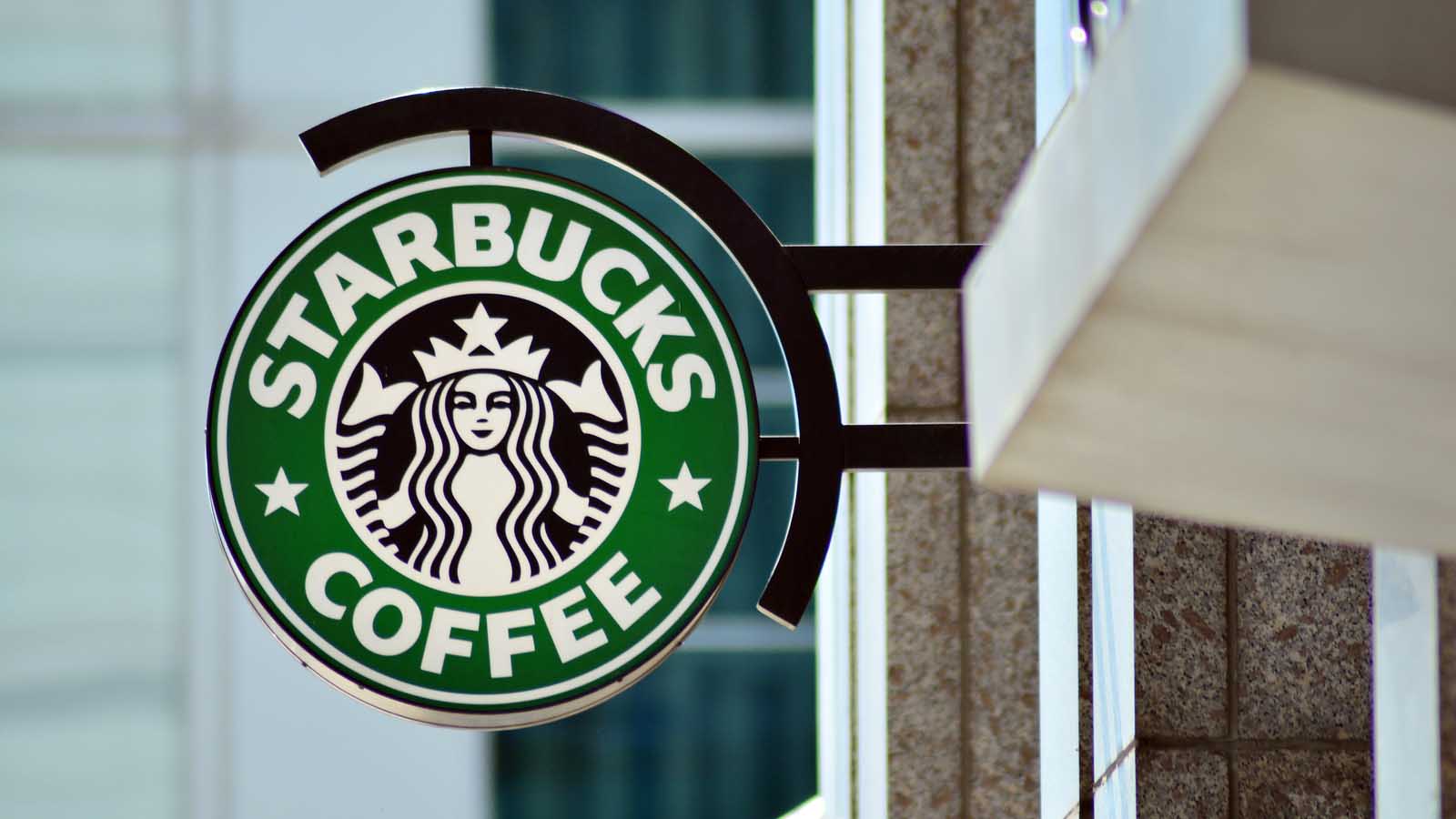 Starbucks Red Cup Day 2022 the Starbucks (SBUX Stock) logo on a sign outside of a coffee shop