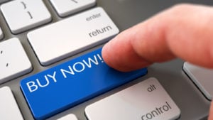 Stocks to buy: A close-up shot of a hand pressing a "BUY NOW!" button on a laptop keyboard. stocks to buy