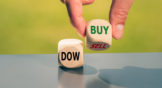 Two dice with the word "Dow" on one and "Buy" on the other