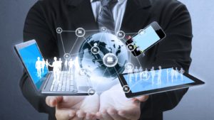 Image of a man holding multiple devices and a graphic that connects all of them