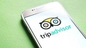 image of mobile phone screen displaying tripadvisor logo (TRIP)