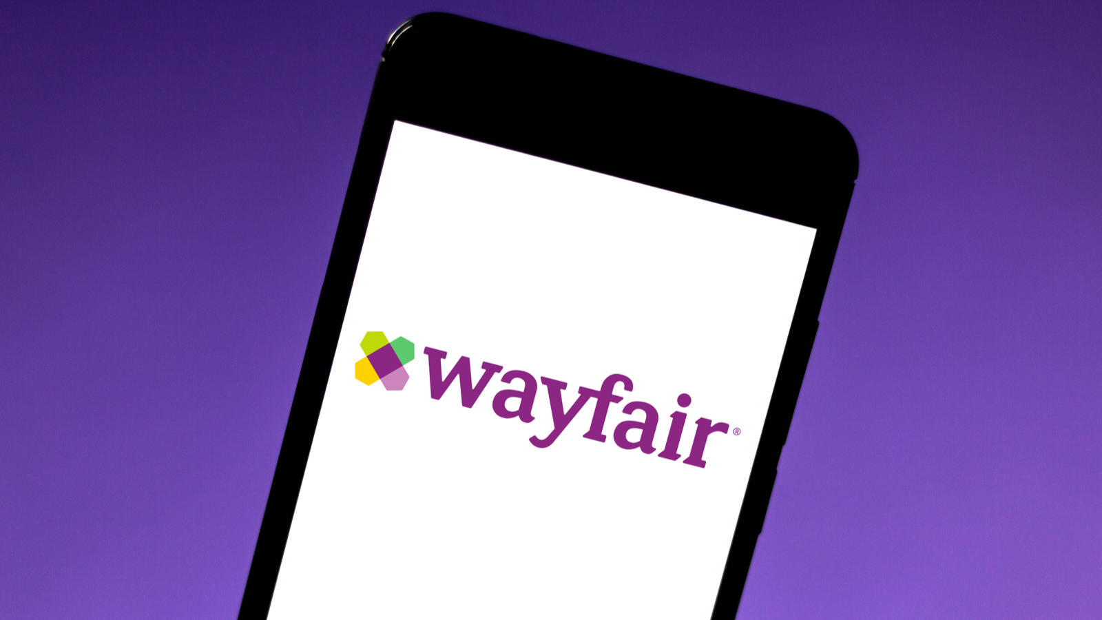 The Wayfair (W Stock) logo on the screen of a mobile phone with a purple background