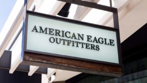 A photo of an American Eagle Outfitters Inc (AEO) sign hanging above a retail storefront entrance.