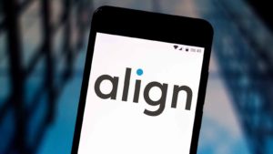a smartphone displays the Align (ALGN) logo