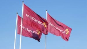 The AstraZeneca plc (AZN) logo is displayed on three waving red flags.