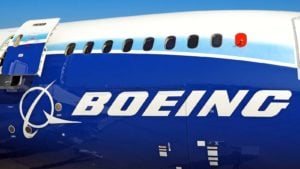 Boeing Company passenger airplane with open exit door passenger windows cargo door Boeing logo close up view