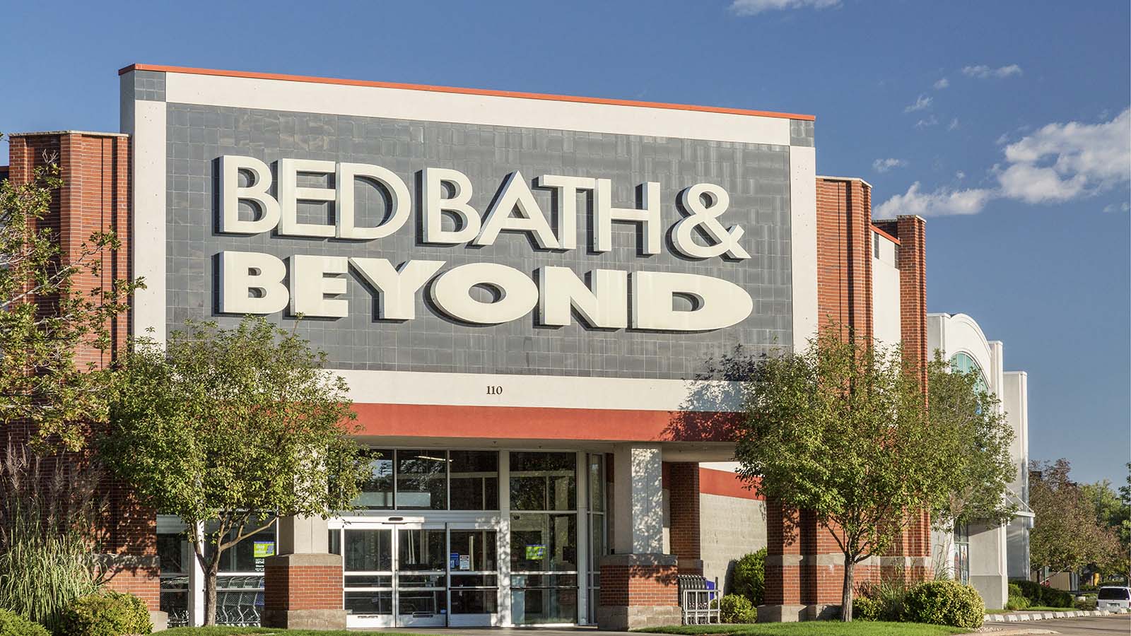 Bed, Bath & Beyond (BBBY) storefront with trees in front