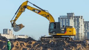 A Caterpillar backhoe at the top of a hill