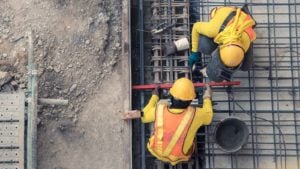 construction workers work on a concrete floor