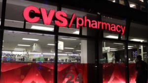 A photo of the CVS logo over the door of one of its stores representing CVS Store Closings.